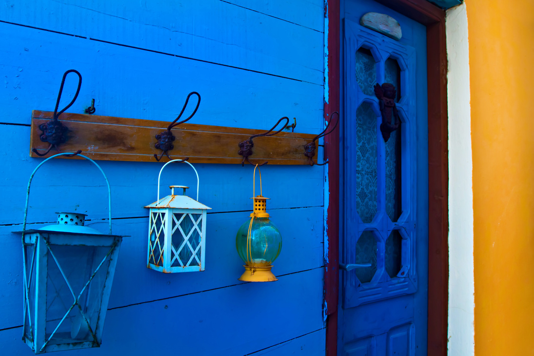 Samos island. Greece. Samos Kokkari Village. Colorful wall and blue, white, yellow lanterns.